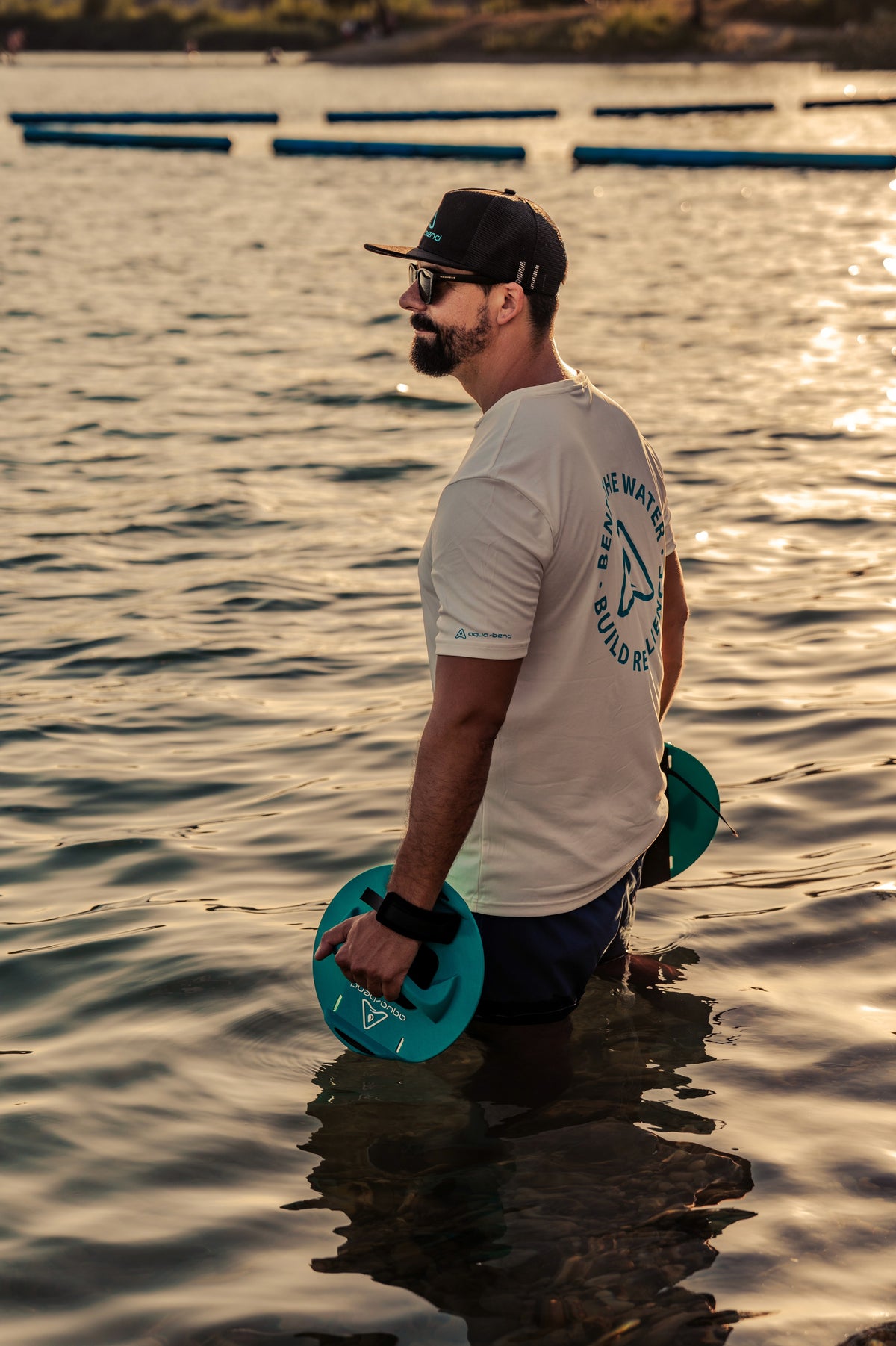 Man standing in open water holding Aqua-Bend discs